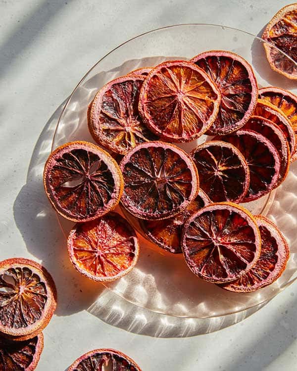 Dehydrated blood oranges on a plate. slices