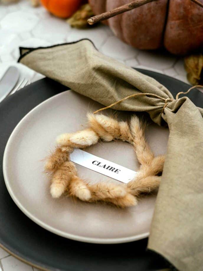 Mini wreath place card on a plate for Thanksgiving. 