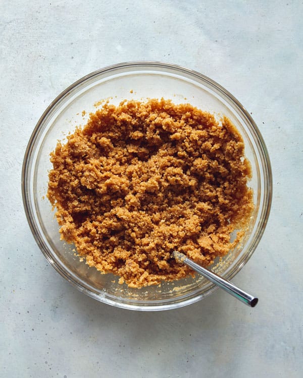 French silk pie crust ingredients in a bowl with a spoon in it.