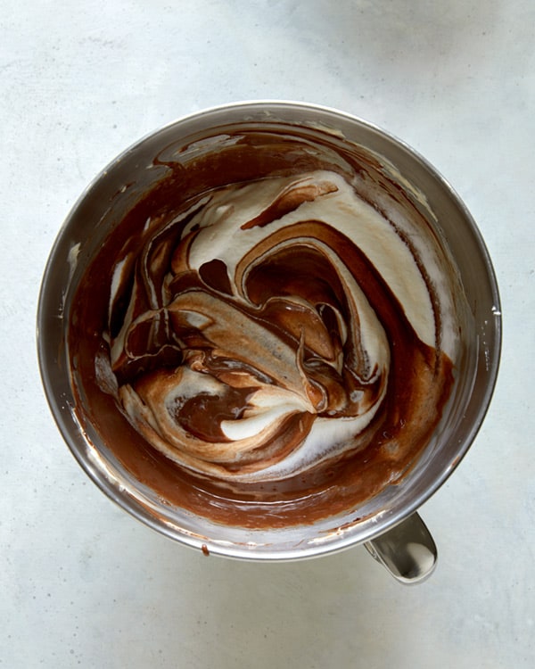 Whipped cream combined with chocolate in a bowl.