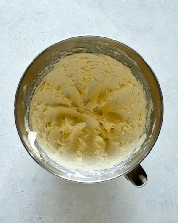 Beaten butter in a dish with a stand mixer.