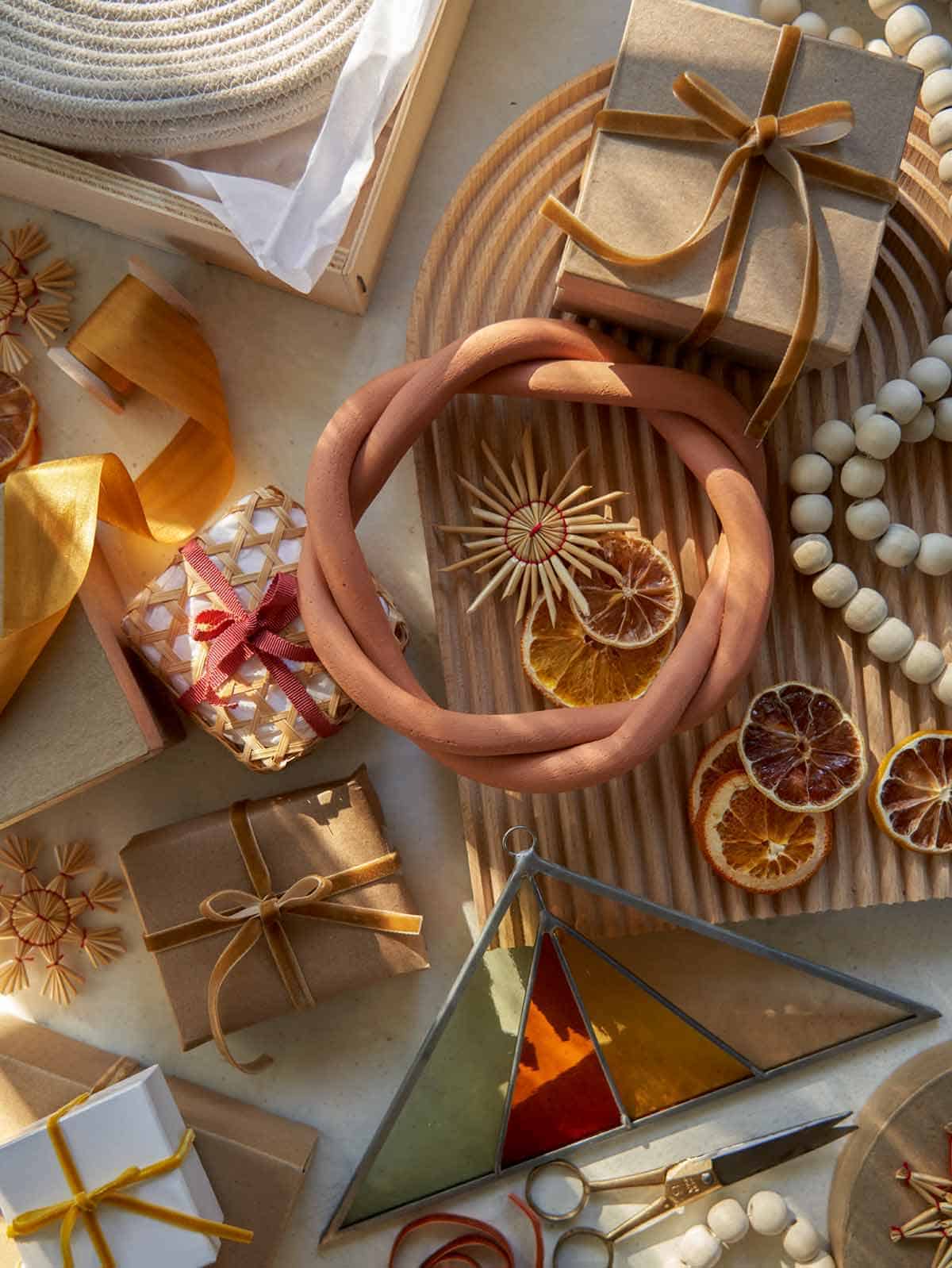 A shot of wrapping gifts with ribbon and Christmas ornaments.