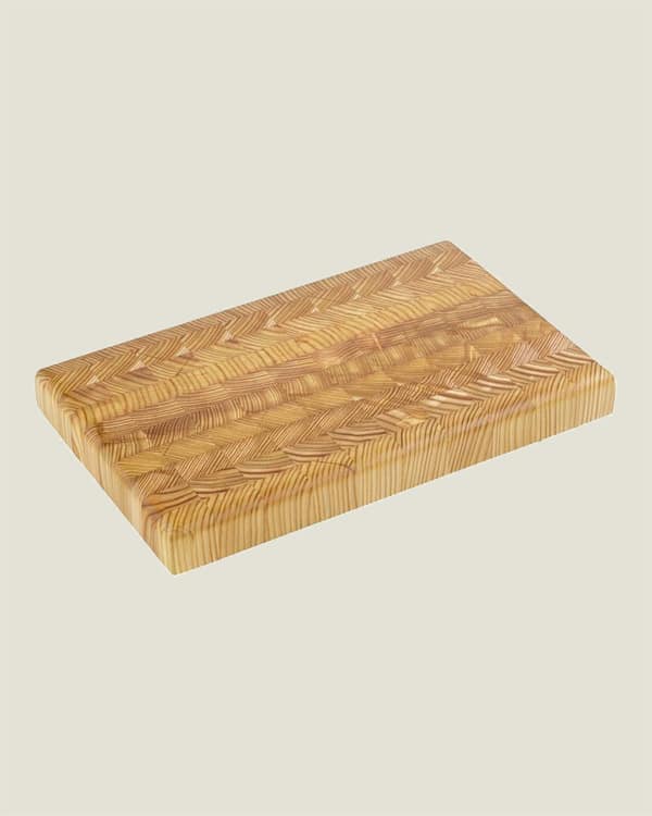 A Canadian wood cutting board on a tan  background. 