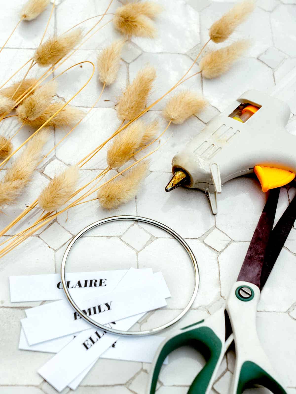 Mini wreath place cards supplies on a table.