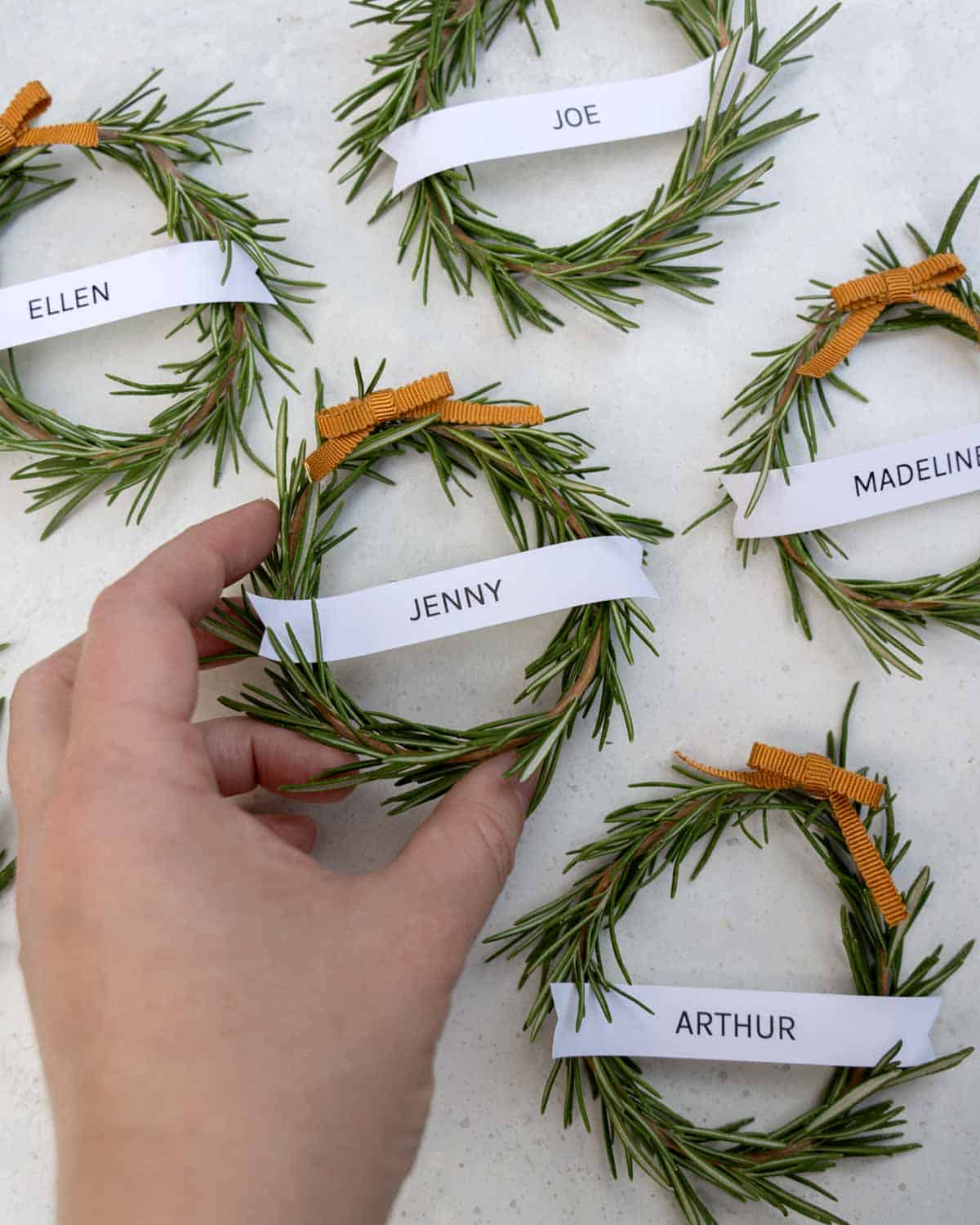 Rosemary wreaths all laid out on a surface. 