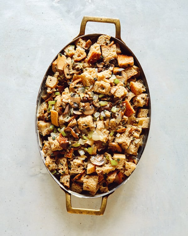 A baking dish full of stuffing pre baked.