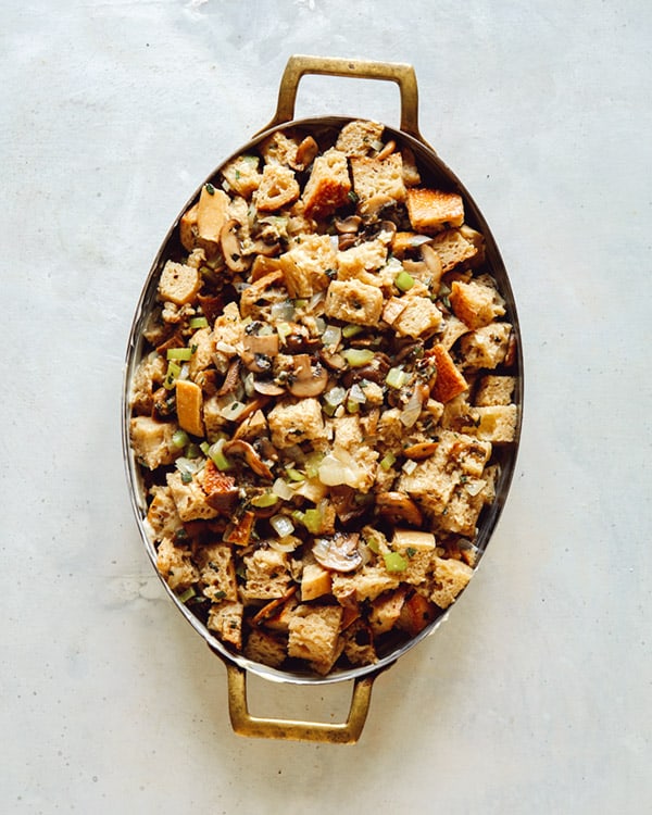 A baking dish full of stuffing pre baked. 