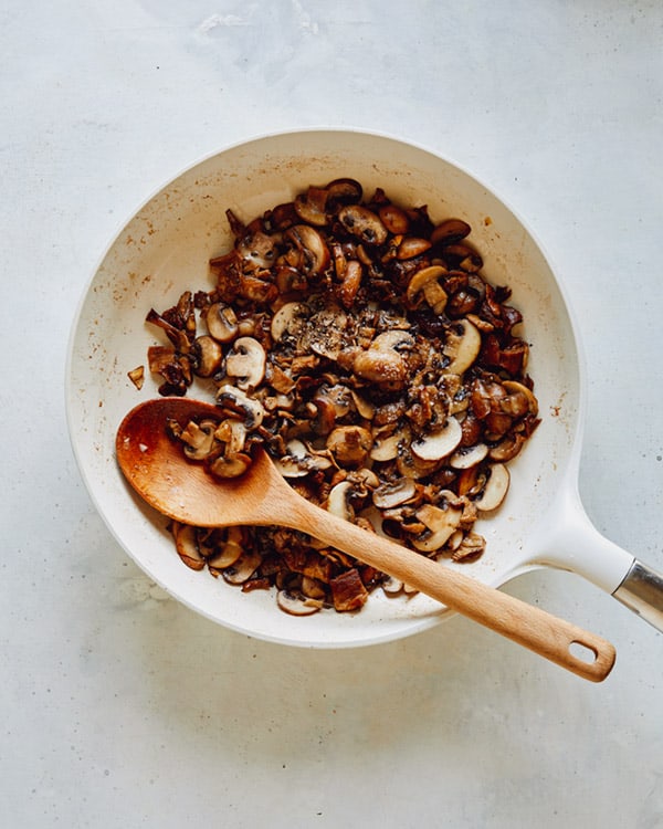 Mushrooms sauted in a skillet.