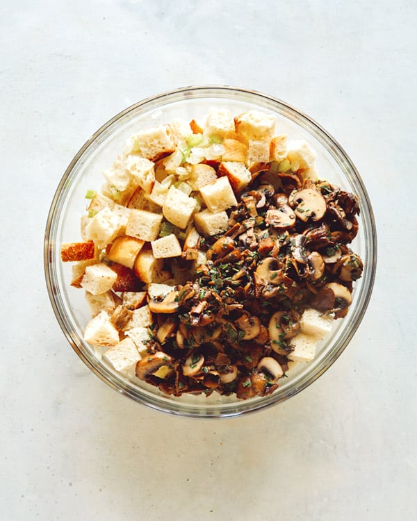 A glass bowl full of mushroom and sage stuffing. 