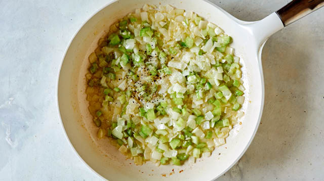 Melt butter and sauté onion, celery and garlic. Season with salt and pepper in a skillet.