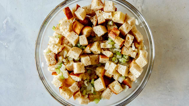 Stuffing mixed together in a glass bowl.