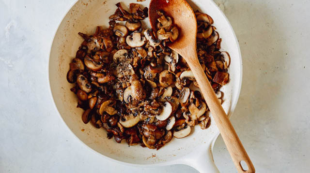 Mushrooms sauted in a skillet.