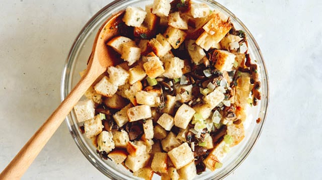 A bowl of mushroom and sage stuffing on a kitchen counter.