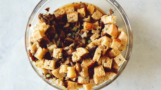 A bowl of stuffing on a kitchen counter.