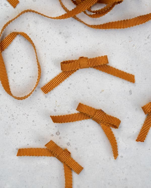 Bows made out of mustard colored ribbon.