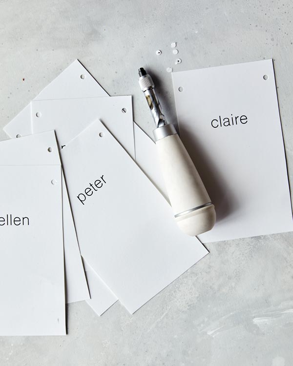 Rosemary Sprig Place Cards with holes punches into the sides.