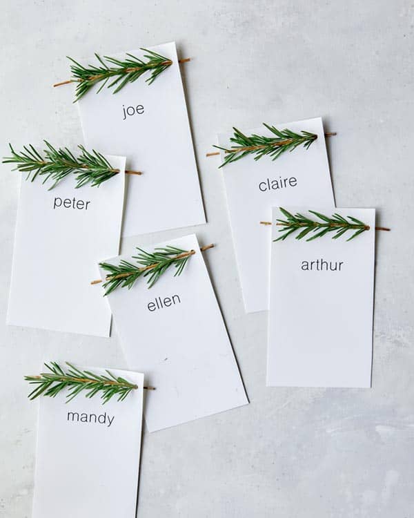 Rosemary Sprig Place Cards laid out on a  surface. 