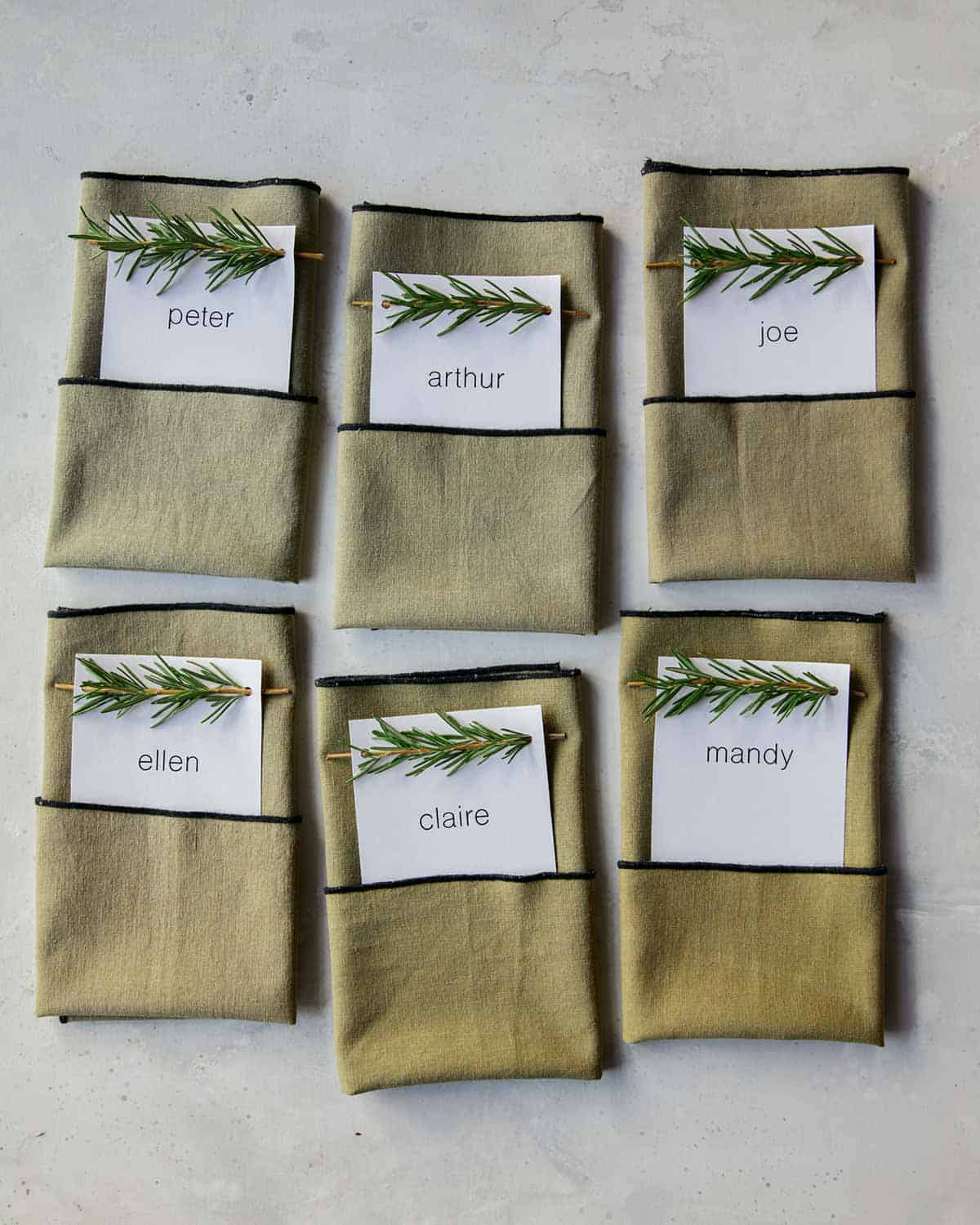 Rosemary Sprig Place Cards tucked into napkins. 