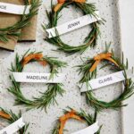 Rosemary wreath place cards on a platter with a napkin.