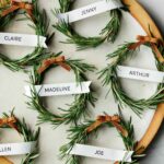 Rosemary wreath place cards on a platter with a napkin.