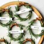 Rosemary wreath place cards on a platter with a napkin.