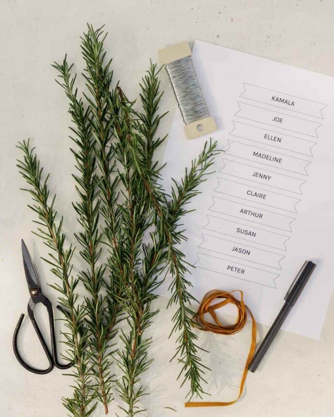 Supplies for rosemary wreath place cards on a surface.