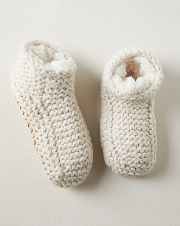 Cozy slippers on a warm colored surface. 