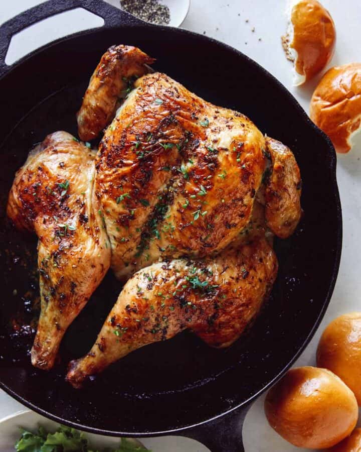 Spatchcock chicken in a skillet freshly roasted.