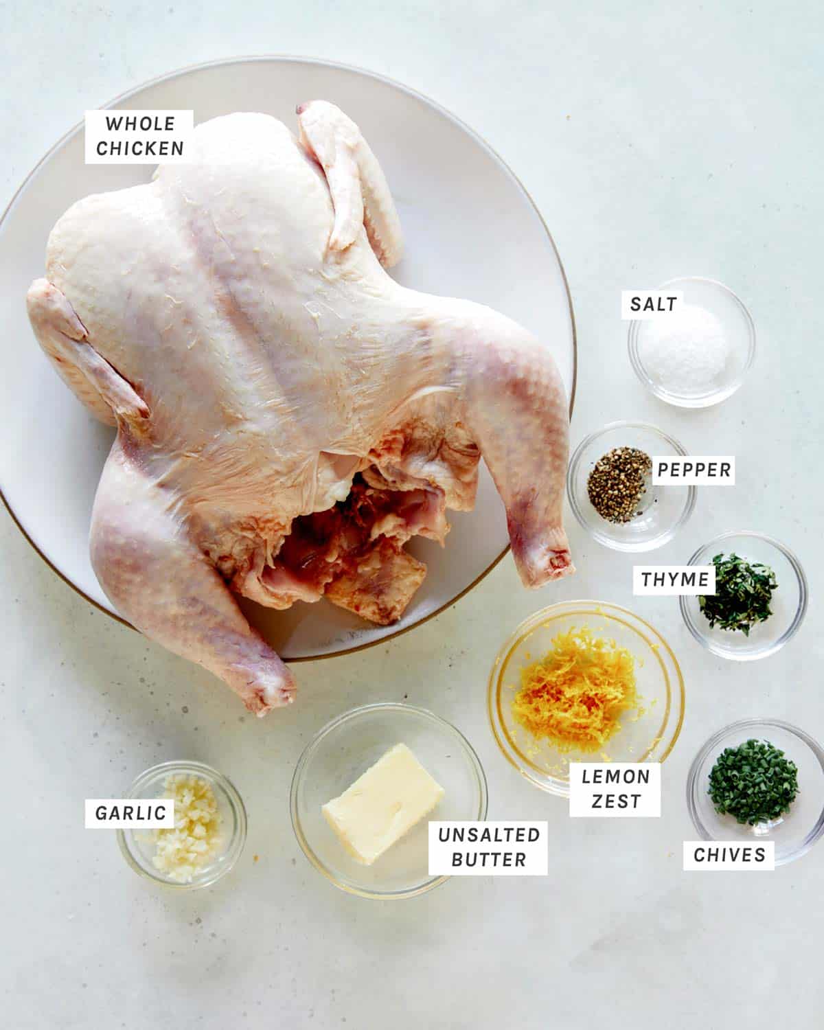 Ingredients to make Spatchcock chicken all laid out on a kitchen counter.