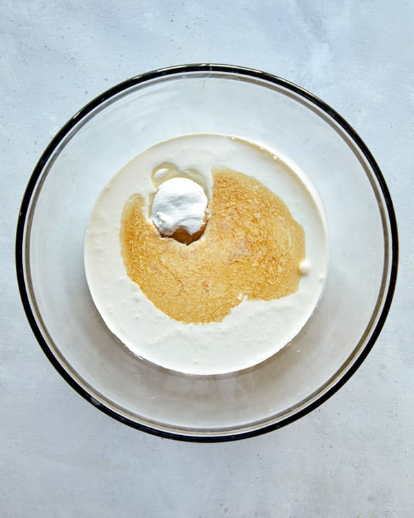 Cream, sugar, and vanilla in a glass bowl for french silk pie topping.