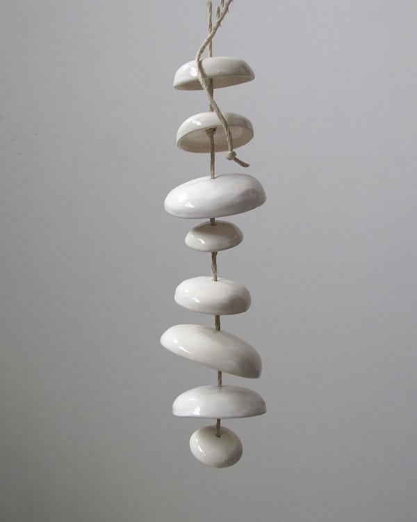 A hand made wind chime on a white background.  