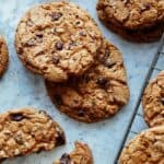 Salted Brown Butter Chocolate and Toffee Chips cookies on a surface with milk.