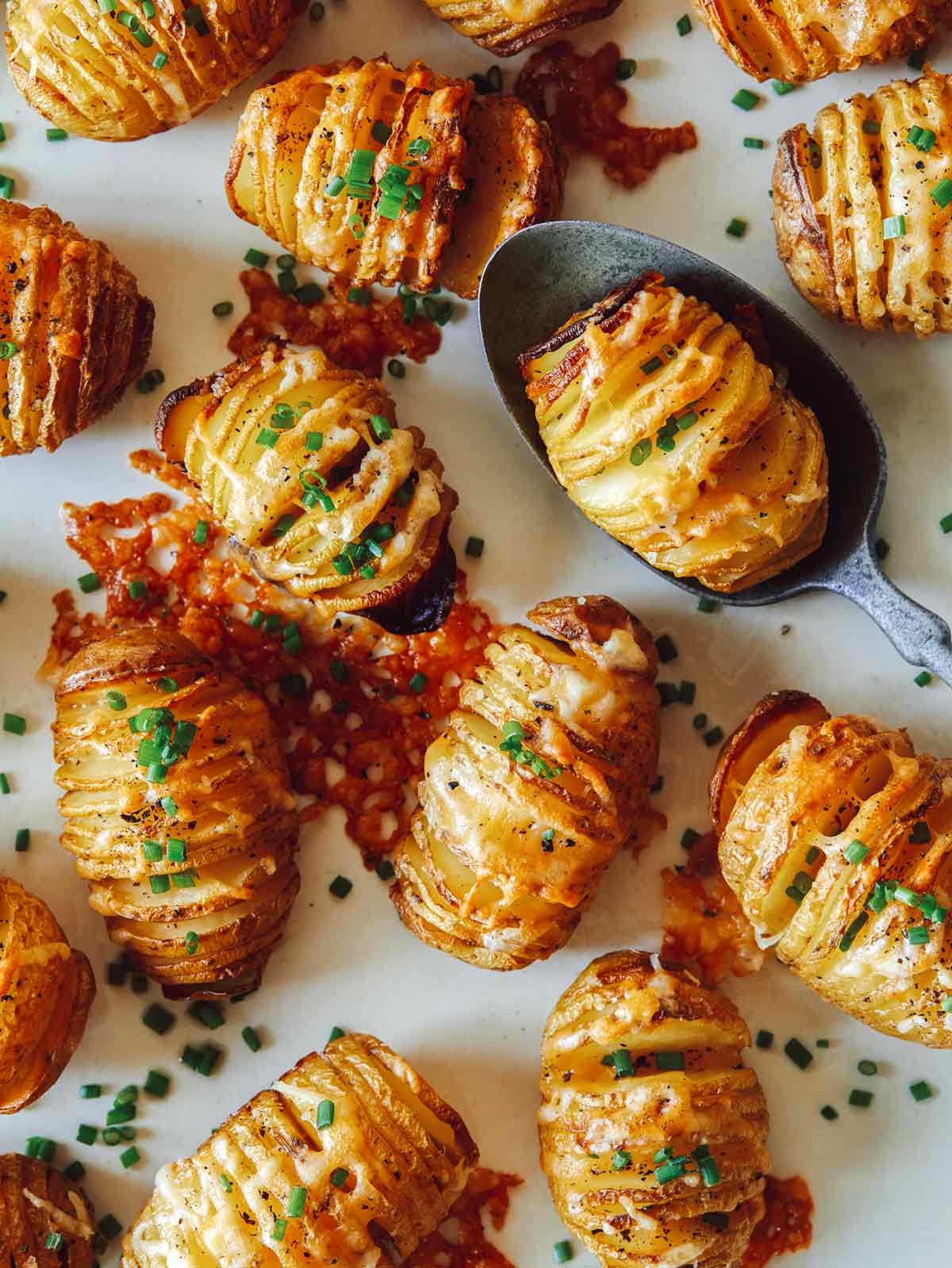 Mini cheesy hasselback potatoes on a platter.