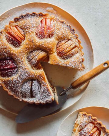 German Apple Cake on a platter with a slice out.