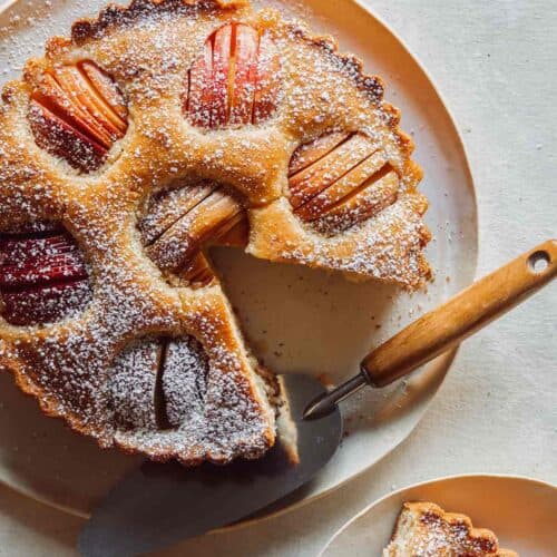 German Apple Cake on a platter with a slice out.