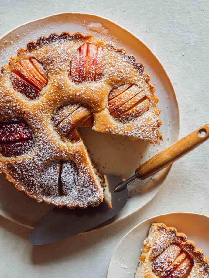 German Apple Cake on a platter with a slice out.