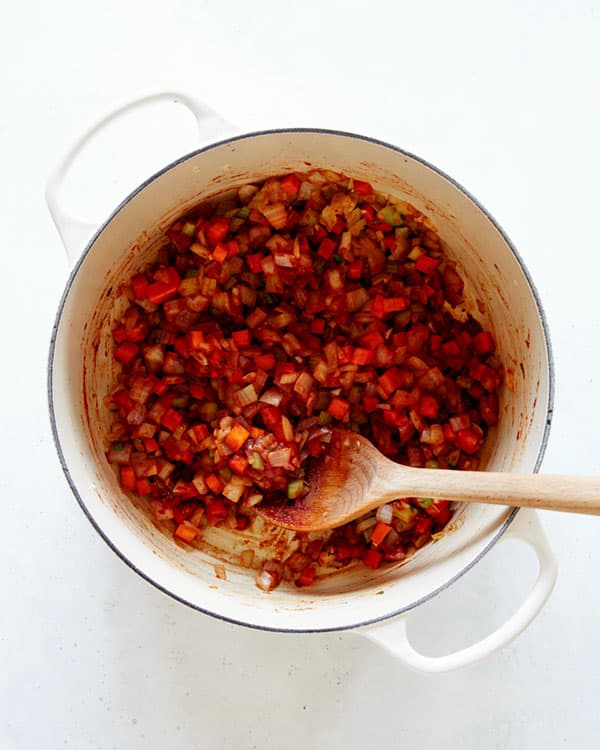 Vegetable and tomato paste in a stock pot.