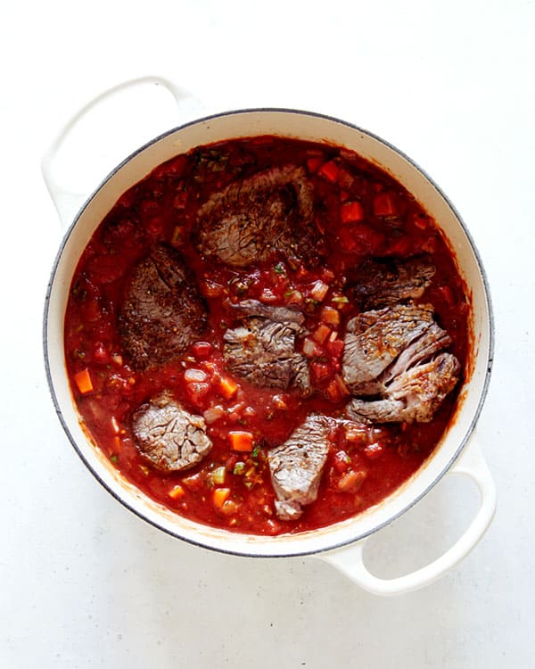Beef in tomato sauce in a stock pot.