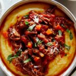 Beef ragu overhead in two bowls with forks.