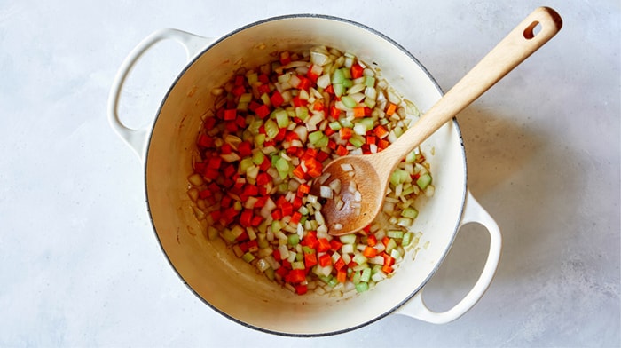 Saute carrots and celery in a stock pot.