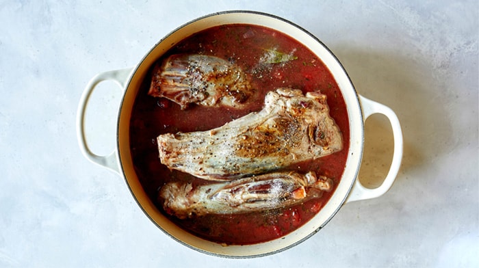 Lamb shanks in a pot ready to be braised.