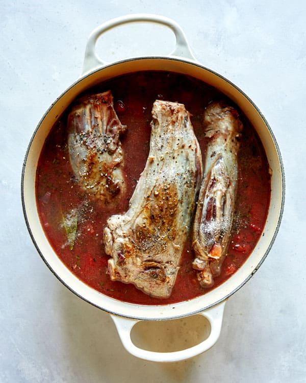 Lamb shanks in a pot ready to be braised.