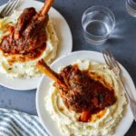 Braised lamb shanks over mashed potatoes.