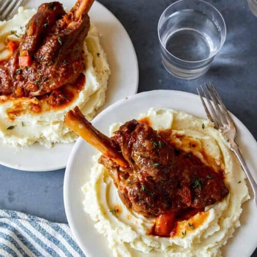 Braised lamb shanks over mashed potatoes.