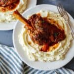 Braised lamb shanks over mashed potatoes.