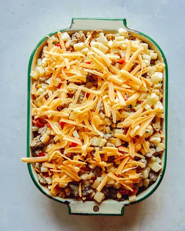 Breakfast casserole with cheese on top to be baked.