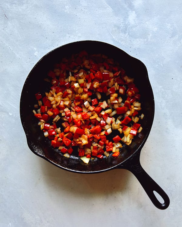Vegetables sautéd in a cast iron skillet.