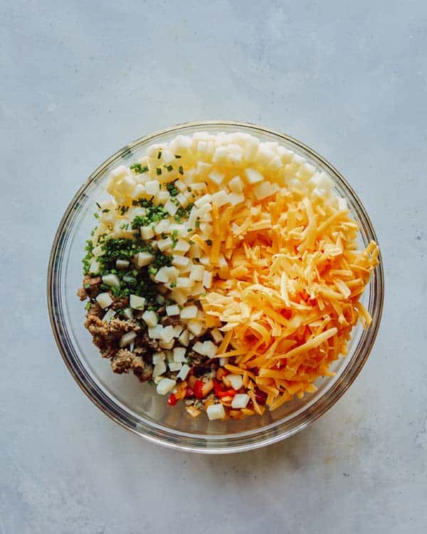 Breakfast casserole mixture in a glass bowl.