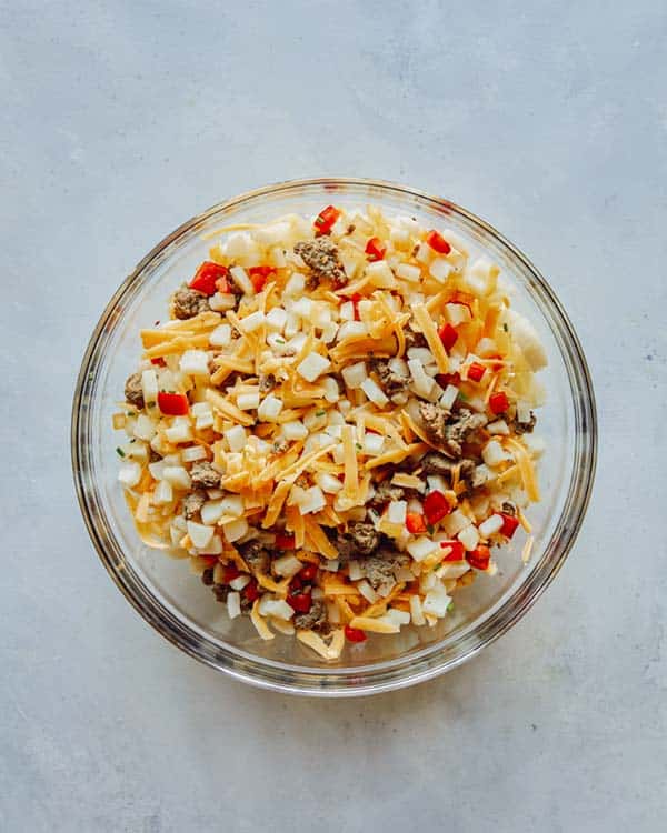Mixing together ingredients to make breakfast casserole.