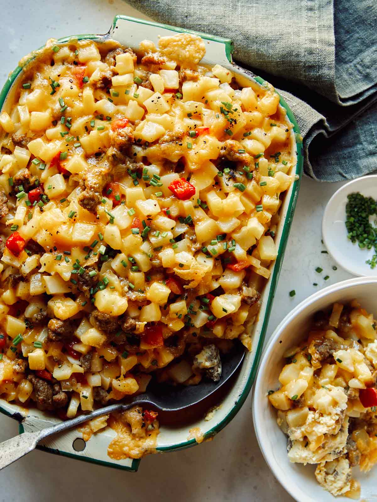 Breakfast casserole with a scoop taken out in a bowl. 